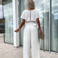 Ensfarget jumpsuit med plisserte ben og høy midje